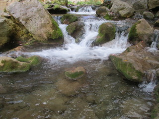 Stream of waterfall in a mountain forest