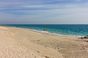 Fototapeta na wymiar Sand beach with blue water on Sir Baniyas Island, Abu Dhabi, United Arab Emirates