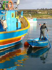 Details of the colourful traditional Maltese fishing boats, the luzzu. Marsaxlokk port, Malta