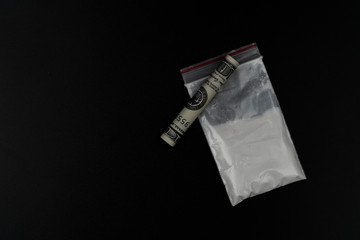 Cocaine or other illegal drugs, white powder, syringe, isolated on black glossy background