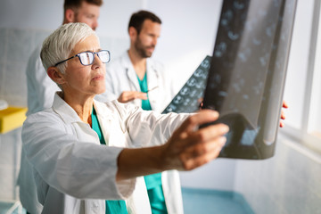 Group of doctors examining an x-ray in hospital to make diagnosis