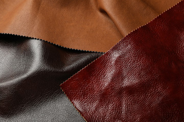 Different leather samples as background, closeup view