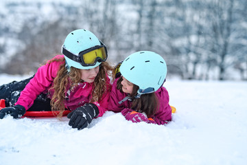 teen friends laugh on a winter day on the ski slope