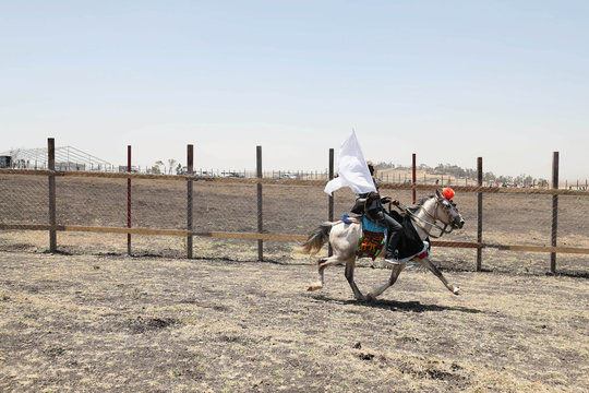A man rides his horse next to the fence of the crash site during a memorial service for the victems of the Ethiopian Airlines Flight ET302 Boeing 737 Max plane crash near Bishoftu