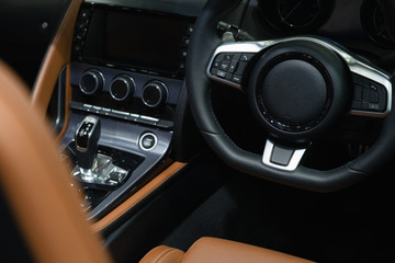 Interior view of  Modern luxury prestige sport car with leather salon, Steering wheel with car controller system function.