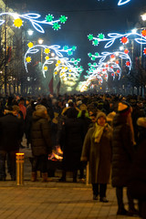 Fototapeta na wymiar VILNIUS, LITHUANIA - FEBRUARY 16, 2020: Hundreds of people attending the celebration of Restoration of the State Day in Vilnius. Bonfires are lit on Gediminas avenue on festive night on February 16.