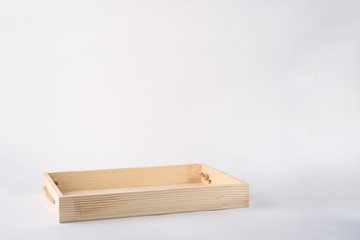 Naklejka na ściany i meble A empty wooden box on white background, top view.
