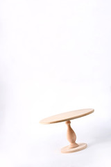 Empty wooden stand for cake isolated on white