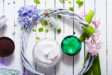 cosmetic cream product samples with hyacinth flowers on white wooden background