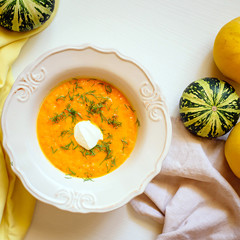 Bowl of pumpkin soup on white background