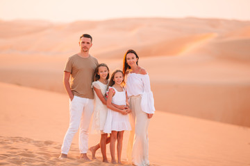 People among dunes in desert in United Arab Emirates