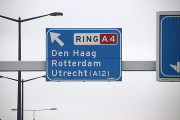 Blue and white direction signs at crossing Prins Clausplein heading Utrecht and Den Haag