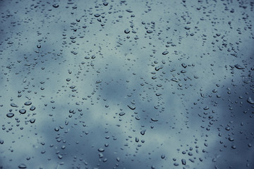 Macro shot of raindrops. Wet window. Bad weather and dark skies.