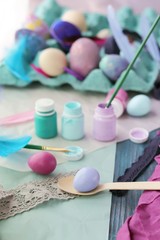 Happy Easter, eggs, paints, brushes, paper on a wooden surface, preparation for the holiday, a symbol of spring