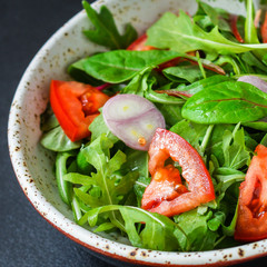 healthy salad tomato, mix leaves, onions and other ingredients, vegan, keto or paleo menu concept....