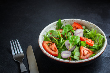 healthy salad tomato, mix leaves, onions and other ingredients, vegan, keto or paleo menu concept. top food background. copy space