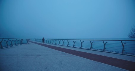 Runner woman running outdoors training for marathon run outdoors in the evening