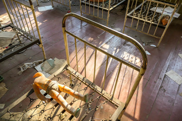 An abandoned kindergarten after the nuclear explosion in Chernobyl, Ukraine. Little beds are rusty...