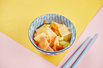 Close up view on traditional kimchi cabbage in blue bowl on colorful background. pan-asian cuisine