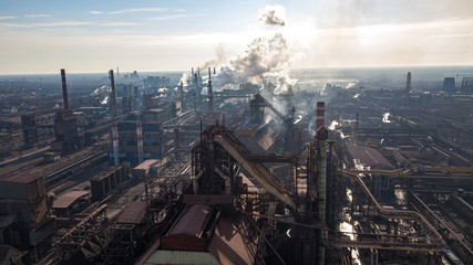 Steel ecology metallurgical iron plant smokes from pollution of industry pipes. View from the drone.