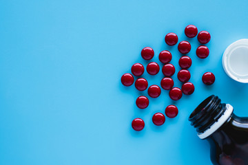 Blood tonic includes multivitamins, folic acid, and iron liquid with bottle on blue background for healthcare and medical concept