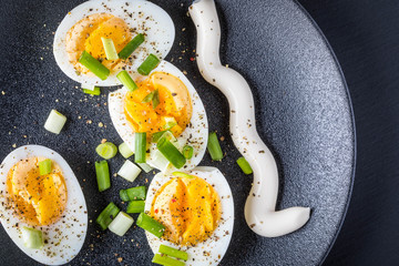 boiled eggs on black plate and background