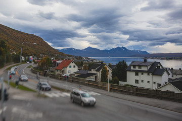 View of Tromso, with cathedral, Tromso Bridge, Tromsoya island, embankment and scenery beyond the city, Troms og Finnmark county, Norway, summer day