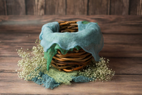 basket made of wood decorated with gypsophila basket for a newborn photo shoot. white gypsophila