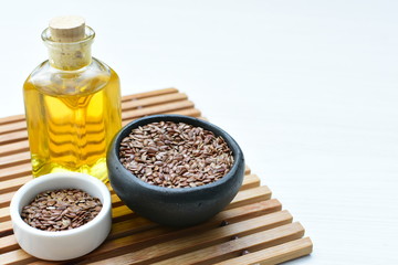 Flaxseed or flaxseed seeds, accompanied by oil (Linum usitatissimum) displayed in containers