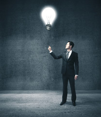 Businessman holding glowing lightbulb