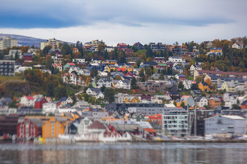 View of Tromso, with cathedral, Tromso Bridge, Tromsoya island, embankment and scenery beyond the city, Troms og Finnmark county, Norway, summer day