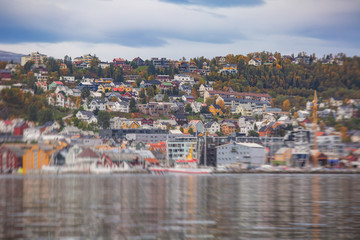 View of Tromso, with cathedral, Tromso Bridge, Tromsoya island, embankment and scenery beyond the city, Troms og Finnmark county, Norway, summer day