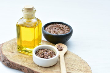 Flaxseed or flaxseed seeds, accompanied by oil (Linum usitatissimum) displayed in containers
