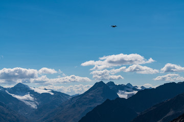 Drone flies mountains and peaks landscape in the background. Hills covered with glaciers and snow, natural environment. Hiking in the Gaislach. Ski resort in Tirol alps, Austria, Europe
