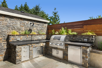 Home exterior backyard hardscape outdoor entertainment and cooking area with barbecue