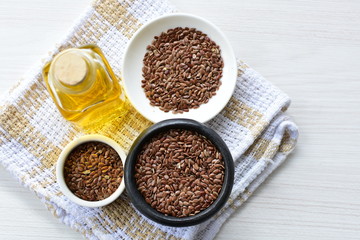 Flaxseed or flaxseed seeds, accompanied by oil (Linum usitatissimum) displayed in containers