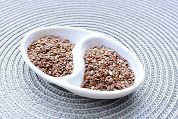 Flaxseed or flaxseed seeds, accompanied by oil (Linum usitatissimum) displayed in containers
