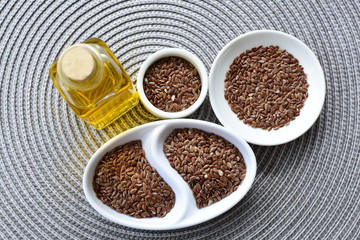 Flaxseed or flaxseed seeds, accompanied by oil (Linum usitatissimum) displayed in containers