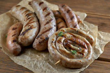 grilled sausages on a wooden background