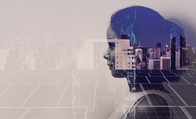 Double exposure of Asian woman silhouette and modern renewable city skyline background.Energy...