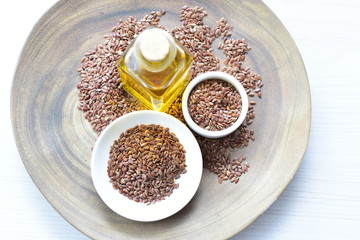 Flaxseed or flaxseed seeds, accompanied by oil (Linum usitatissimum) displayed in containers