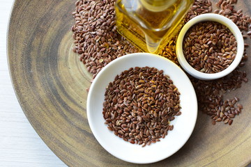 Flaxseed or flaxseed seeds, accompanied by oil (Linum usitatissimum) displayed in containers