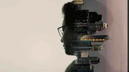 Double exposure of Asian woman silhouette and modern renewable city skyline background.Energy...