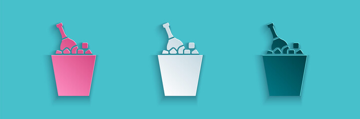 Paper cut Bottle of champagne in an ice bucket icon isolated on blue background. Paper art style. Vector Illustration © Vadim