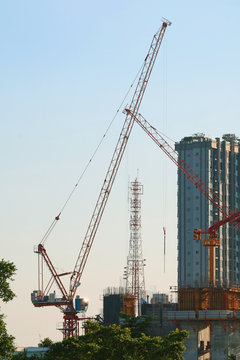 Vertical image of two cranes on the construction site