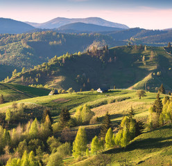 Alpine mountain village on a green rolling hills