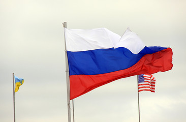Russian flag on the background of the American and Ukrainian flag