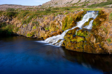 Iceland waterfall closeup view of the gods cliff with long exposure smooth motion of water in summer landscape