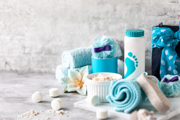 Spa accessories - sea salt, powder, tablets for a bath, pumice, cream on a light background. Healthy lifestyle concept. Cosmetics for skin care feet. Decor for the bathroom.