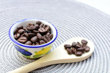 Colombian coffee beans, displayed in containers and spoons